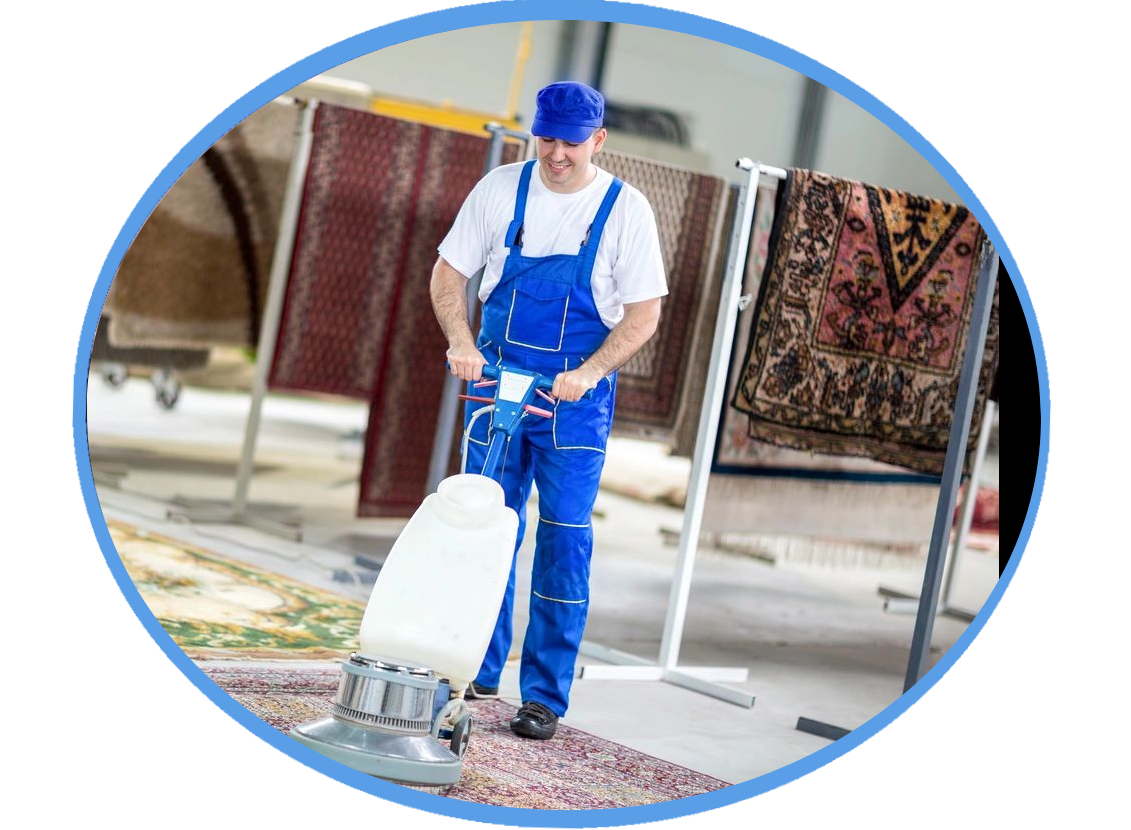A man in blue overalls is vacuuming